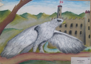 Praca plastyczna przedstawiająca orła z rozłożonymi skrzydłami. W tle zamek.
