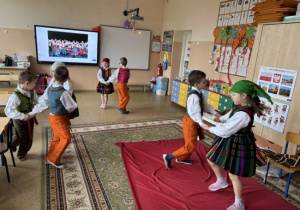 Dzieci tańczą w opoczyńskich strojach ludowych