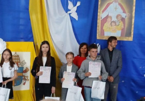 Grupa uczniów z dyplomami od organizatorów konkursu, a wśród nich Kaja.