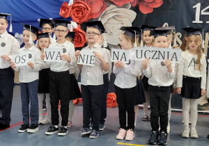Uczniowie klasy pierwszej na scenie podczas swojego pasowania.